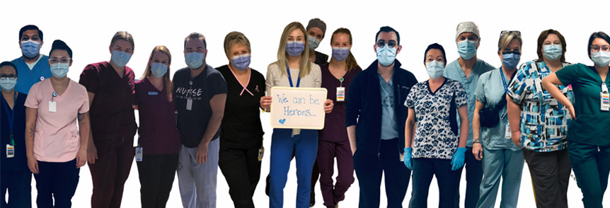 Group of healthcare workers wearing masks with one person holding a sign that reads we can be heroes